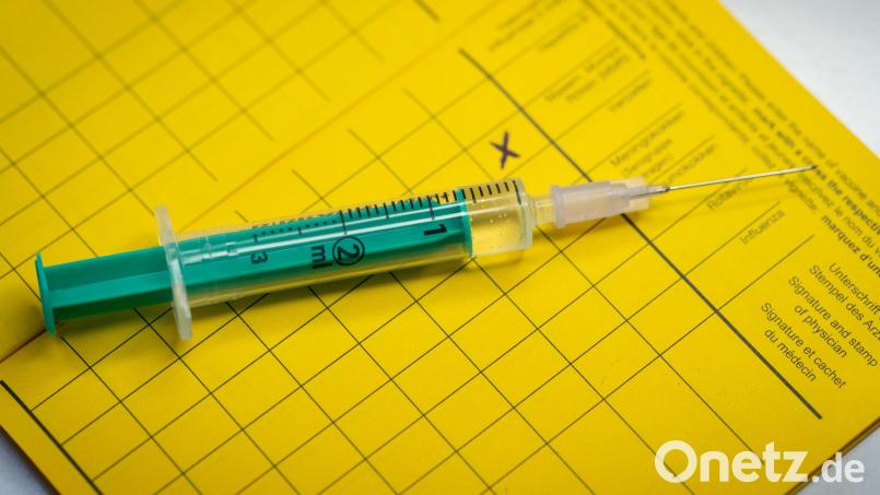 Eine Spritze liegt auf einem Impfpass. Foto: Friso Gentsch/dpa/Illustration Bild: Friso Gentsch