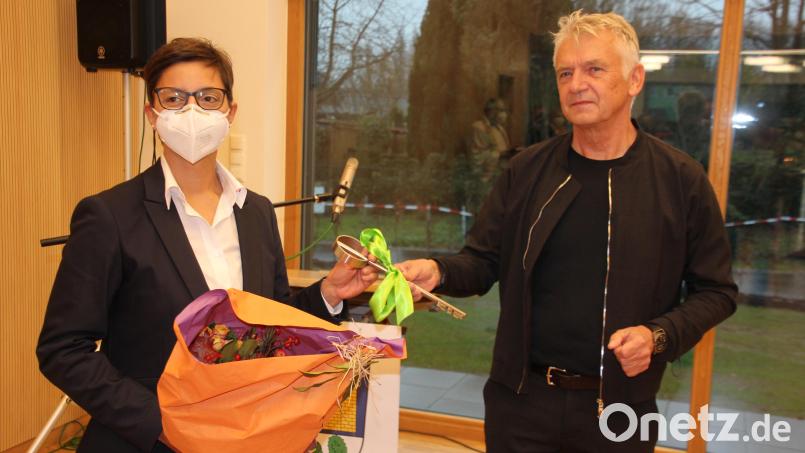 Architekt Ulrich Greiner überreicht Kindergartenleiterin Martina Fuhrmann den Schlüssel für den neuen Kindergarten und einen Blumenstrauß. Bild: kro
