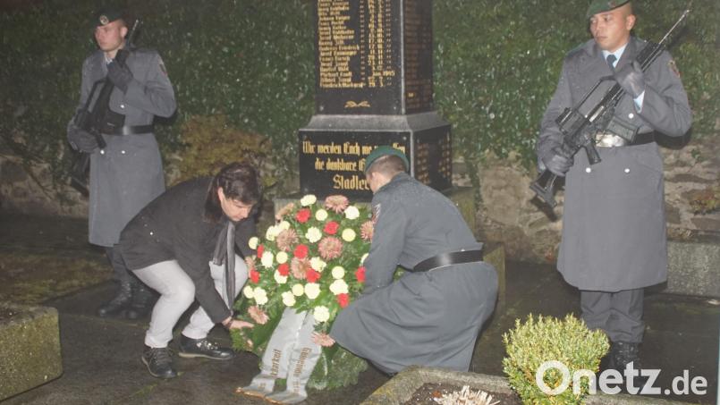 Gemeinsam legen Bürgermeister Gerald Reiter und Feldwebel Carsten Lehner am Kriegerdenkmal, flankiert von Soldaten des 4. Panzergrenadierbataillons 122, einen Kranz nieder. Bild: mmj