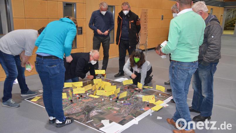 Mit roten und grünen Punkten sowie Merkzetteln markierten die Bürgerinnen und Bürger an der ersten Station auf einem Luftbild relevante Orte mit Handlungsbedarf. Bild: ak
