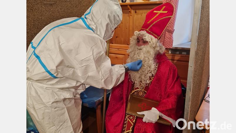 Getestet haben ehrenamtliche Helfer der BRK-Bereitschaft Mitterteich alle Beteiligten der Nikolaus-Hausbesuche am Sonntag „in Zivil“, aber für ein paar Symbolfotos zur Erinnerung an die besondere Aktion nahmen einige Mitglieder des 
Burschenvereins und der Pfadfinder später noch einmal voll eingekleidet Platz. Bild: BRK Mitterteich/exb