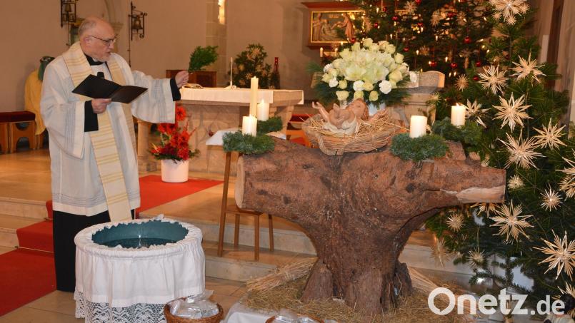 Stadtpfarrer Anton Witt segnet die Utensilien der Sternsinger, mit denen sie hinaus zu den Menschen geschickt werden. Im Mittelpunkt der Aussendung stand die Segnung des Dreikönigswassers. Bild: jr
