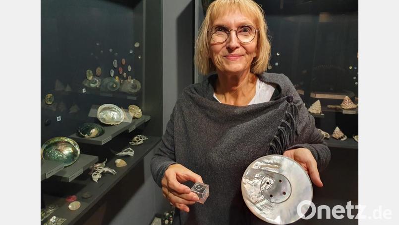 Andrea Bäuml mit dem größten und kleinsten Perlmuttknopf der Welt. Bild: Joachim Walther/exb