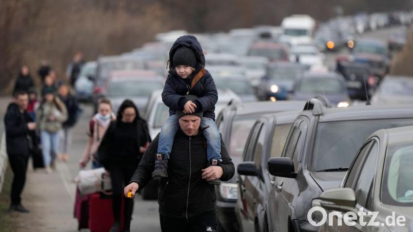 Aus der Ukraine geflüchtete Menschen am Grenzübergang Mayaky-Udobne. Wegen des russischen Angriffs auf ihre Heimat sind Hunderttausende auf der Flucht. Bild: Sergei Grits/AP/dpa