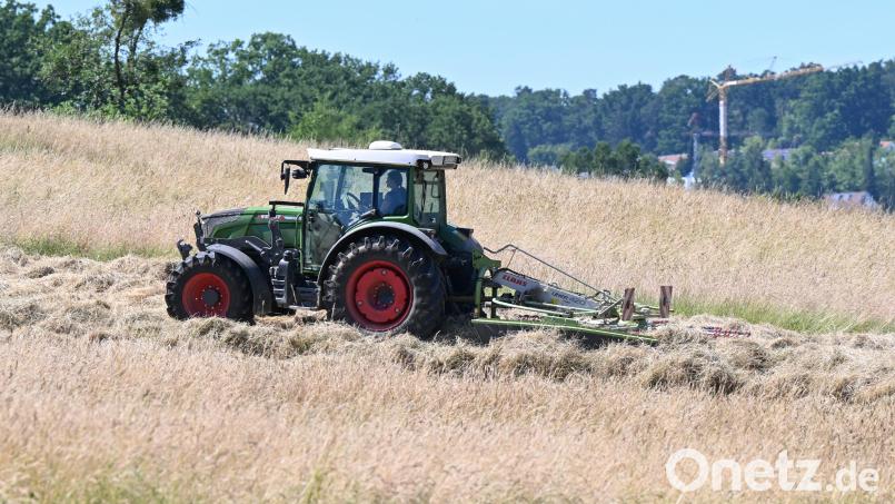 Ein Traktor steht auf einer Wiese. Symbolbild: Bernd Weißbrod/dpa