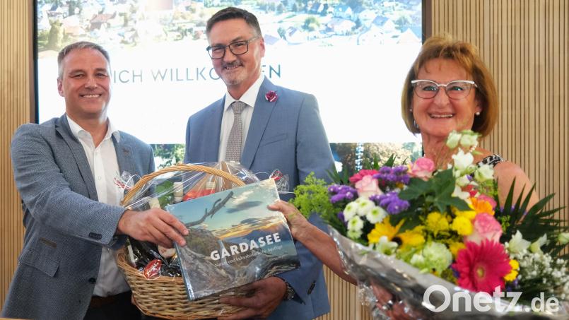 Zweiter Bürgermeister Thomas Rohrwild (links) überreichte den "Italienfreunden" Irmgard und Hans Prechtl Blumen, einen Geschenkorb und ein Buch über den Gardasee. Bild: Hirsch