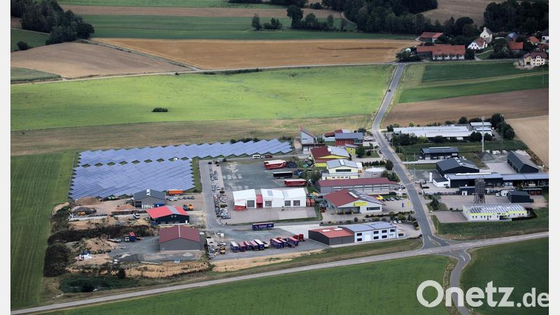 Der Stadtratsbeschluss (Ratsbegehren) sieht die Erweiterung des Industriegebietes West, in Verbindung mit einer Freiflächen-Photovoltaikanlage bis zur Teunzer Straße (oben) vor. Da ein breiter Grüngürtel als Abstand zur Ortschaft Hof (rechts) in die Planung einfloss, würde eine weitere PV-Anlage über der Straße (Feld links oben) entstehen. Die BI „Hof plus“ will die PV-Anlagen mit dem Bürgerbegehren verhindern. Luftbild: akp