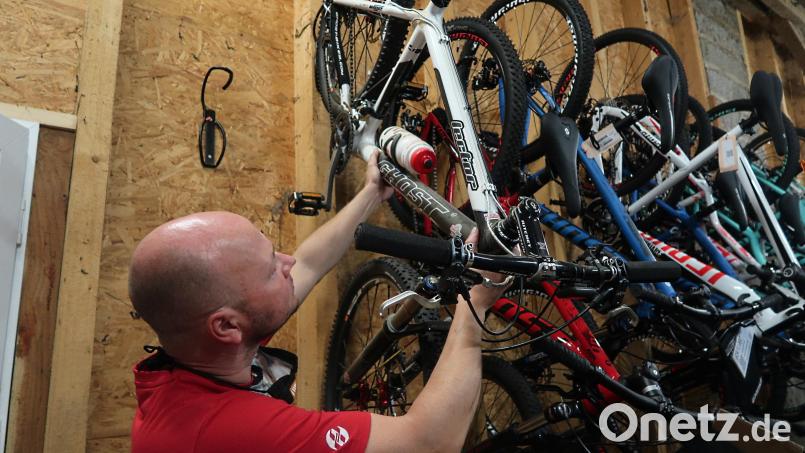 Rainer Ziegler von der „Bike Station“ in Weiden zeigt, wie sich ein Fahrrad mit wenigen Handgriffen an der Wand befestigen lässt. Er warnt aber auch davor, ein schweres E-Bike an den Haken zu hängen. Bild: Helmut Kunz