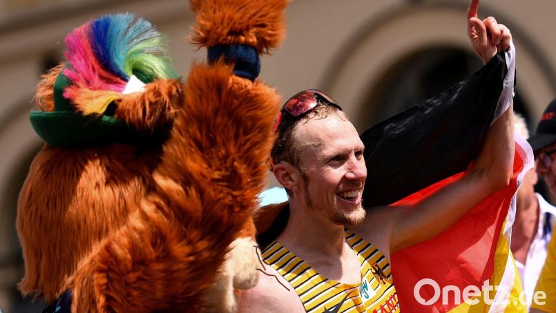 Richard Ringer (rechts) feiert seinen EM-Sieg mit Maskottchen Gfreidi. Bild: Marius Becker/dpa