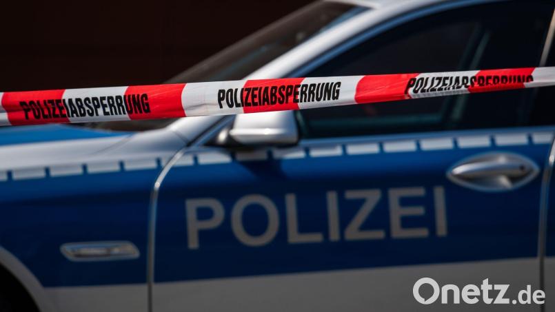 Ein Polizeiauto steht hinter einem Absperrband der Polizei. Bild: Robert Michael/dpa-Zentralbild/dpa/Symbolbild