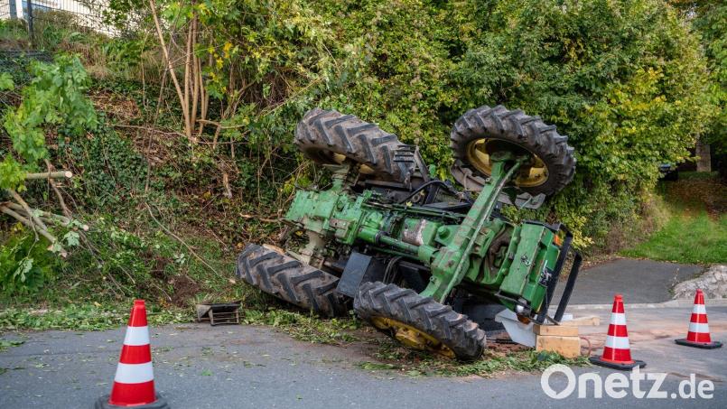 Der Traktor liegt neben einer Böschung auf der Seite. Bild: Bauernfeind/vifogra/dpa
