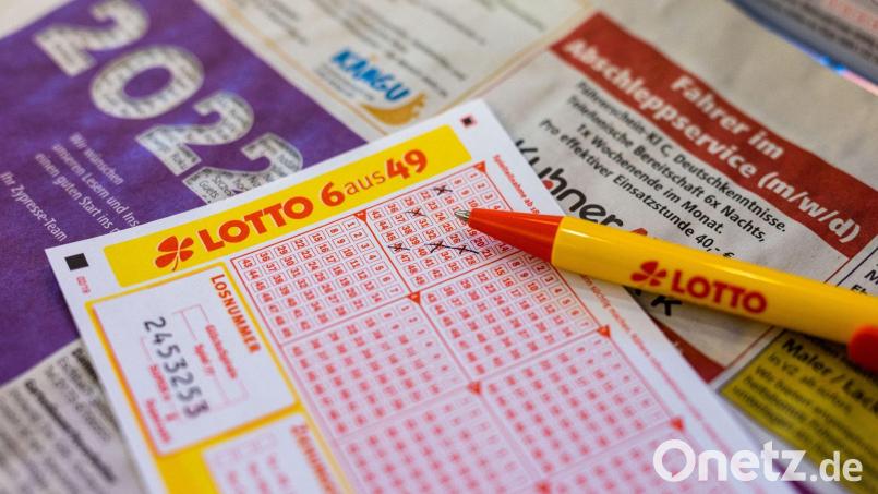 Ein Lottoschein und ein Kugelschreiber liegen in einer Annahmestelle auf dem Tresen. Bild: Philipp von Ditfurth/dpa/Illustration/Symbolbildarchiv