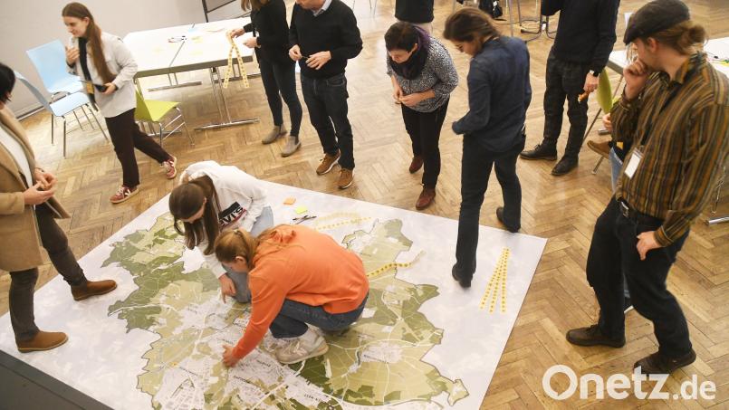 Die Teilnehmer des Jugendworkshops &quot;Dein Weiden 2040&quot; kleben Punkte mit Veränderungsvorschlägen auf eine Karte von Weiden. Bild: Gabi Schönberger