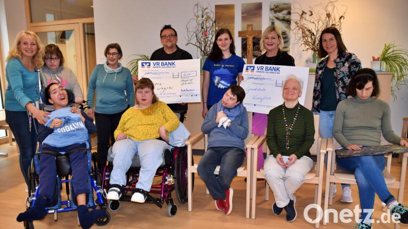 Paula Trautmann (stehend, Fünfte von links) übergab die Spenden der Kunstausstellung an Heimleiter Georg Müller (stehend, Vierter von links) und Rektorin Stefanie Lutye-Küst (stehend, Zweite von rechts). Bild: wku