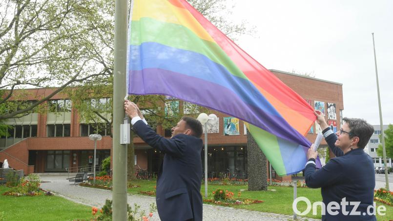 Oberbürgermeister Jens Meyer (links) und die Gleichstellungsbeauftragte der Stadt Weiden, Susanne Reinhardt, hissen vor dem Neuen Rathaus die Regenbogenfahne. Damit wollen sie ein Zeichen gegen die Diskriminierung von queeren Menschen setzen. Bild: Gabi Schönberger