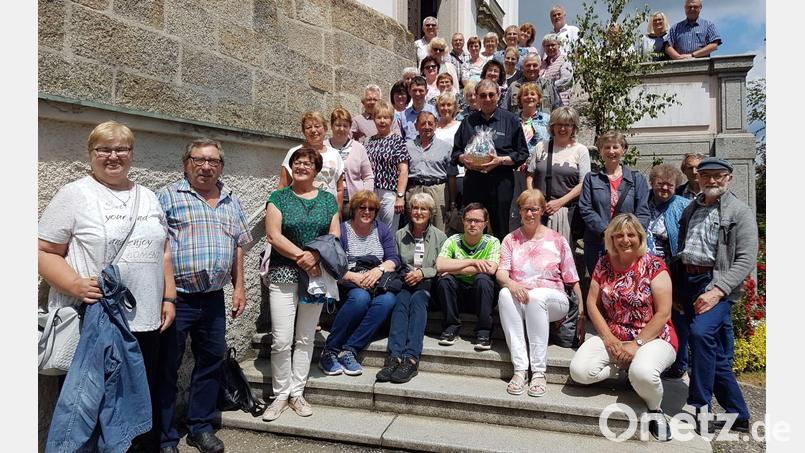 Pleysteins ehemaliger Stadtpfarrer Pater Hans Ring wird von der Reisegruppe des Katholischen Frauenbundes nach der Führung durch die Wallfahrtskirche Pöstlingsberg in die Mitte genommen, nachdem ihm vorher noch ein Korb mit Oberpfälzer Köstlichkeiten übergeben worden war. Bild: bey