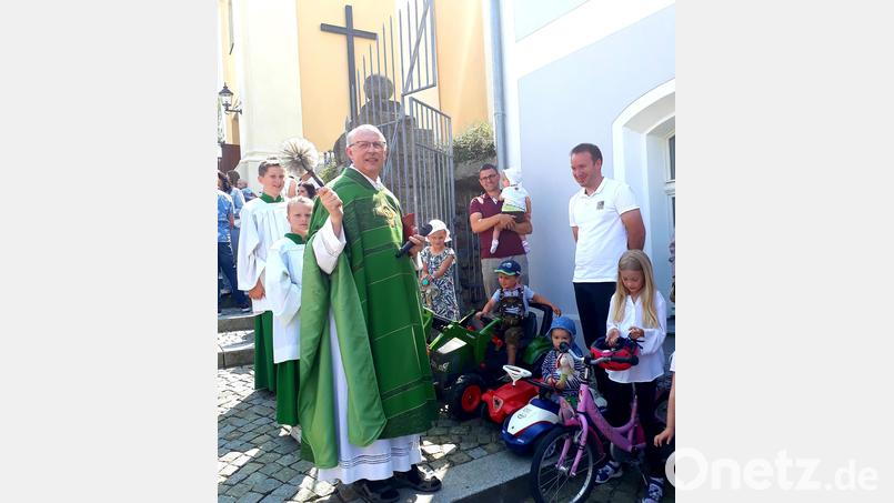 Pfarrer Herbert Rösl segnete die Lieblingsfahrzeuge der Kinder. Bild: Marina Lohrer/exb