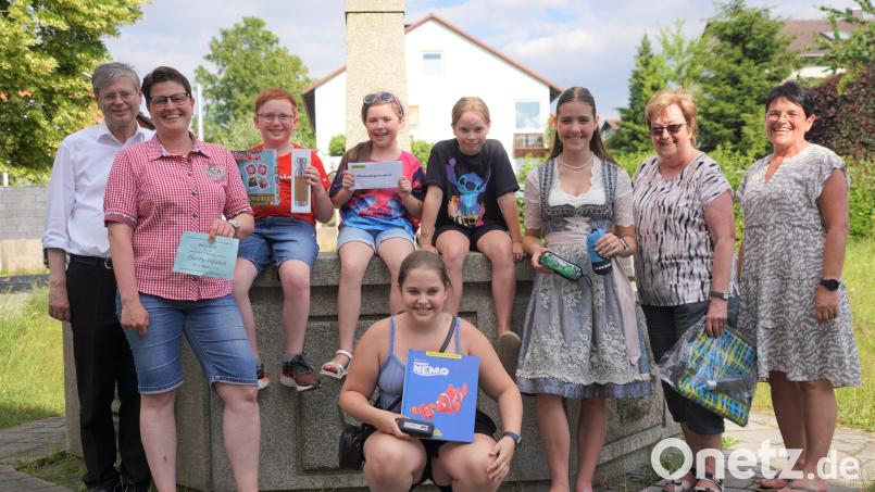 Die Gewinner des Jubiläums-Kirchweih-Quiz freuen sich mit Pfarrer Norbert Götz (links) und PGR-Sprecherin Birgit Bergmann (rechts) über ihre Preise. Bild: fvo