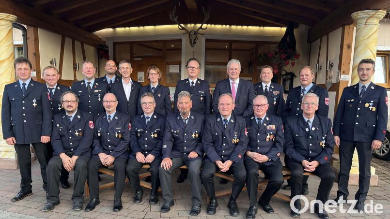 Für 25 beziehungsweise 40 Jahre aktiven Dienst bekommen Feuerwehrleute aus der Gemeinde Ursensollen das Ehrenzeichen in Silber und Gold. Landrat Richard Reisinger und Kreisbrandrat Christof Strobl (stehend, Vierter und Fünfter von rechts) händigen die Ehrenzeichen in Anwesenheit von Bürgermeister Albert Geitner (stehend, Fünfter von links) aus. Bild: Christine Hollederer/exb