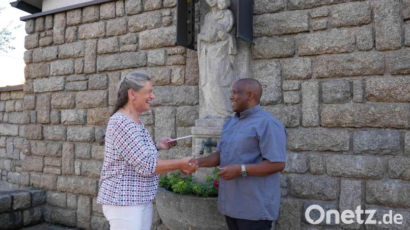 Die Seniorenleiterin Elisabeth Würfl übergibt Kaplan Basil Bazir Ngwega 300 Euro für seine Heimatpfarrei in Tansania. Bild: gz