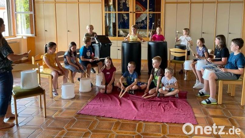Die Kinder lernen beim Ferienprogramm in Tännesberg, wie man mit ausgedienten Alltagsgegenständen Töne erzeugen und Musik machen kann. Bild: Patricia Schneider/exb