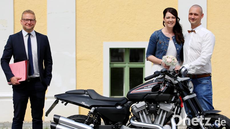 Stefanie Kett und Stephan Bösl sind nun ein glückliches Ehepaar. Standesbeamter Stefan Bäuml (links) freut sich, dass das junge Paar ihren Traum vom eigenen Hochzeitsfahrzeug, einem Motorrad, bewahren konnte. Bild: exb