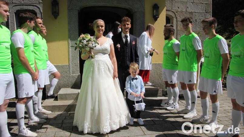 Anna und Christian Ott mit Blumenkind Matteo beim Verlassen der Steinbergkirche. Die Fußballer des TSV Bärnau standen Spalier. Bild: kro
