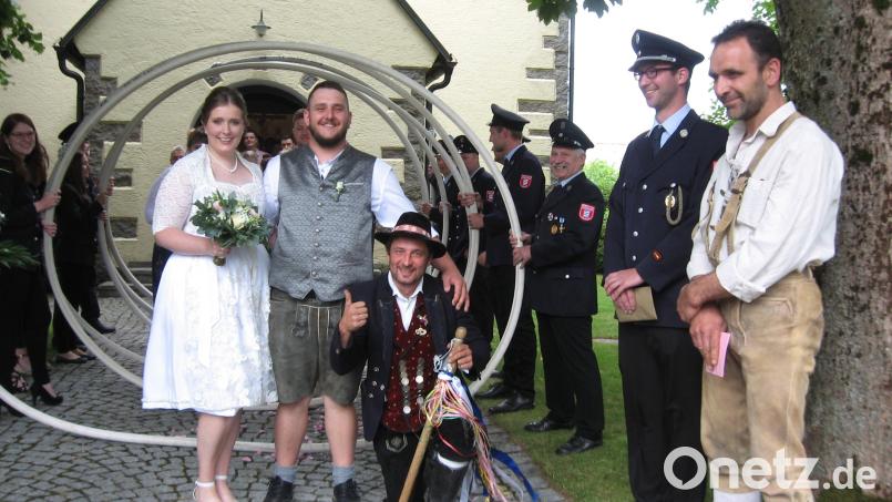 Lisa Bücherl aus Irlach und Patrick Fischer aus Schönsee bahnten sich den Weg ins Eheglück durch eine Schlauchspirale. Auch Hochzeitslader "Fips" war dabei. Bild: wad