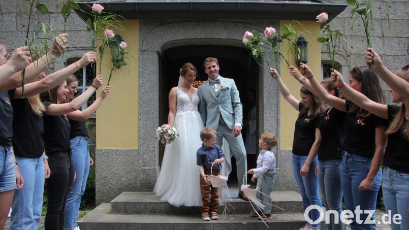 Freudestrahlend und mit ihren beiden Söhnen Paul und Hannes verlassen Anja und David Malzer nach der kirchlichen Hochzeit die Steinbergkirche in Bärnau. Dort erwarteten die Turnerinnen der TG Tirschenreuth auf die Brautleute. Bild: kro