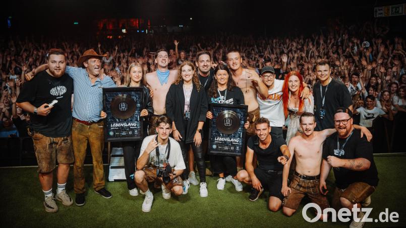 Tream (hinten, Vierter von links) überglücklich: Mit seiner Crew und seiner Familie freut sich der Musiker aus Schwandorf nach einem Konzert in München über die Platin-Auszeichnung für den Song &quot;Lebenslang&quot;. Bild:  Nico Florow/exb