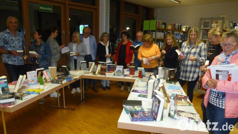 Die Besucher in der Gemeindebücherei schmökern in den Neuerscheinungen, die an drei Tischen präsentiert werden. Hier und in den Sitzecken genossen sie bis Mitternacht die ungezwungene Atmosphäre der Mondscheinausleihe. Bild: bk