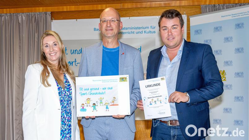Im Bild von links: Anna Stolz (Kultusstaatssekretärin), Alexander Köstler (Rektor der Fichtelnaabtal-Grundschule Ebnath-Neusorg) und Michael Weiß (Vorsitzender der Bayer. Sportjugend). Bild: Julien Becker/exb