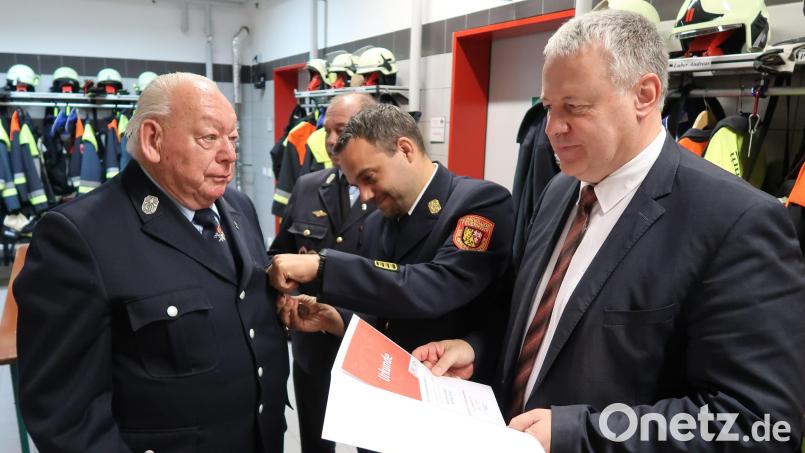 Kreisbrandinspektor Michael Iberer (Mitte) heftete Günther Ernst die hohe Auszeichnung an die Uniform, während Landrat Richard Reisinger die Urkunde des Landesfeuerwehrverbandes vorliest. Bild: rab