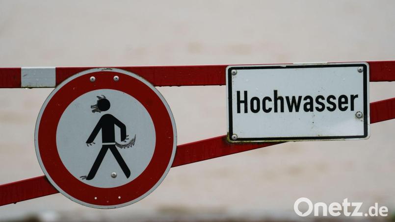 Ein Hochwasser-Schild steht an einem überfluteten Feld. Symbolbild: Andreas Arnold/dpa