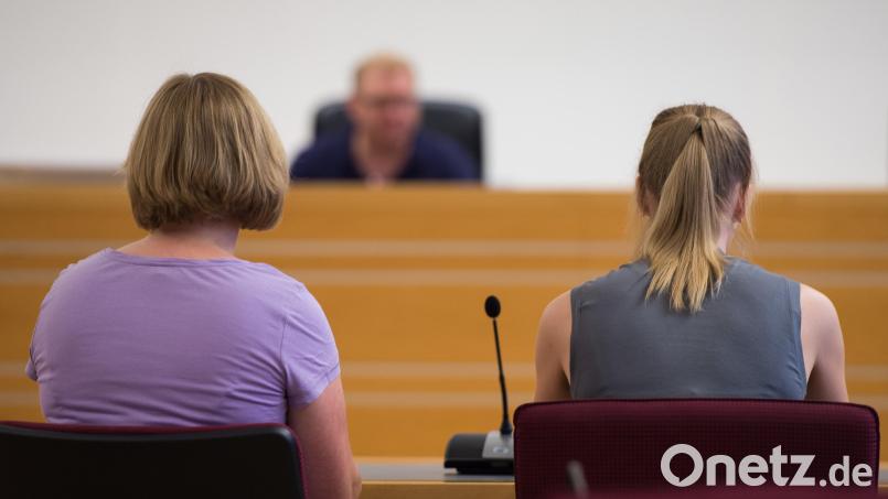 In der gestellten Szene sitzt eine Prozessbegleiterin (links) in einem Gerichtssaal im Landgericht in Hannover (Niedersachsen) neben einem Gewalt-Opfer. Im Hintergrund ist ein Richter zu sehen. Symbolbild: Silas Stein/dpa