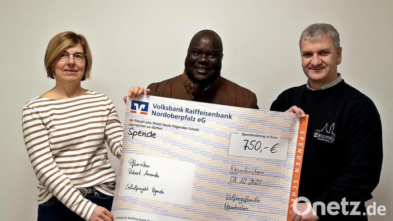 Die Kolpingsfamilie um Kassier Anita Duschner (links) und Vorsitzendem Roland Hoffmann (rechts) überreicht Pfarrvikar Robert Amandu eine Spende für Kinder in Uganda. Bild: R. Kreuzer