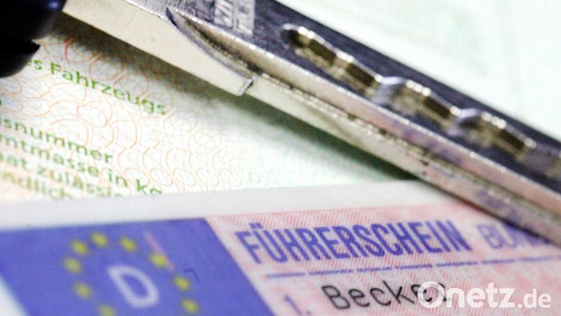 Führerschein und Autoschlüssel liegen auf einem Fahrzeugschein. Im Weidener Rathaus hakte es zuletzt bei der Datenübertragung zur Führerscheinproduktion. Symbolbild: Marius Becker/dpa