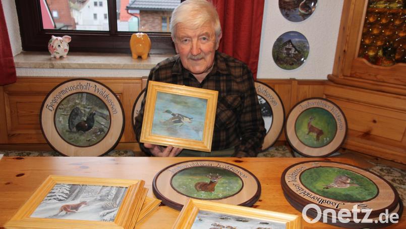 Stolz präsentiert Norbert Fleißner einen Teil seiner bemalten Schützenscheiben und Bilder. Bild: kro