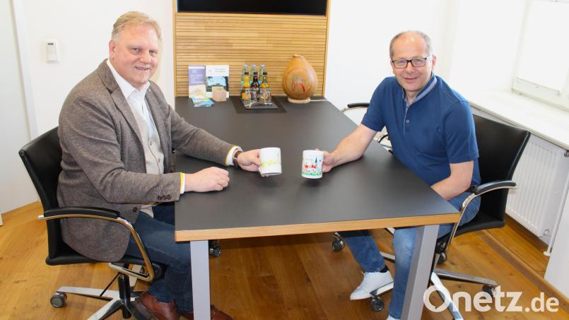 Bürgermeister Roman Schäffler (rechts) hat sich die Frühlingstasse mit dem Kindermotiv ausgesucht. Geschäftsführer Reinhard Herr hat ein Exemplar mit dem Erwachsenenbild genommen. Beide sind schon gespannt, was die Kemnather nun an Sommer-Bildern einschicken werden. Bild: Stadt Kemnath/exb
