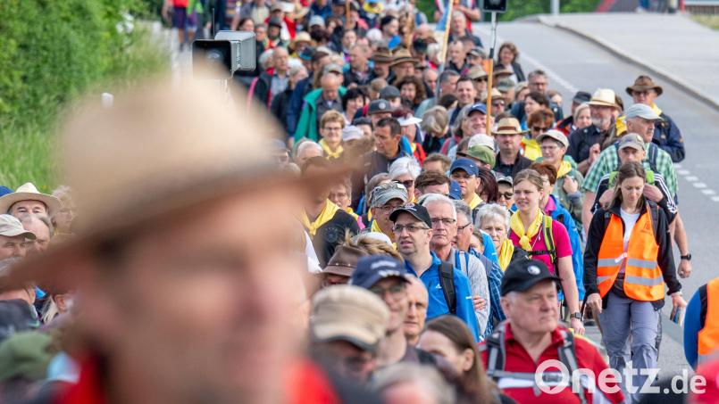 Zahlreiche Pilger starten zur größten Fußwallfahrt Deutschlands. Bis Samstag wollen die Gläubigen von Regensburg aus ins etwa 111 Kilometer entfernte Altötting laufen, dabei schließen sich immer wieder Pilger dem kilometerlangen Zug an. Bild: Armin Weigel/dpa