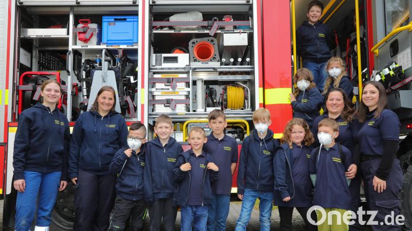 Die Hydrantenbande mit ihren Betreuerinnen und ihren Atemschutzflaschen vor dem Feuerwehrauto. Bild: Wolfgang Steinbacher