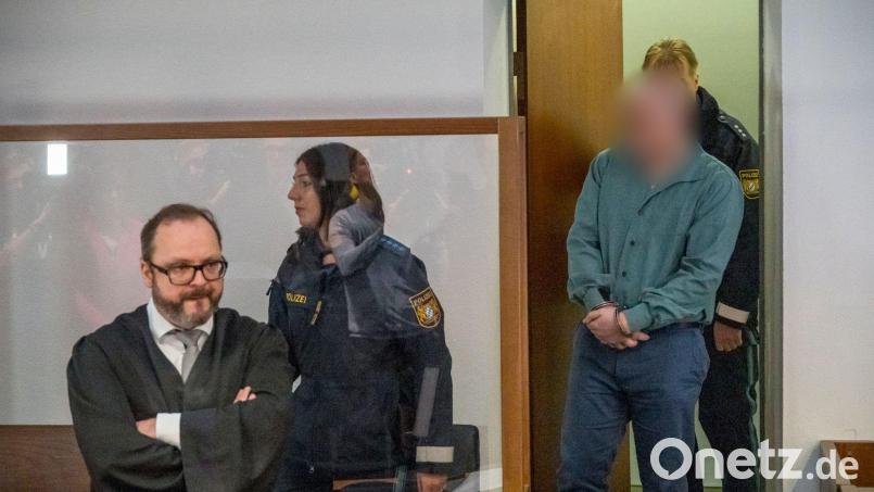 Der Angeklagte (r) wird in den Gerichtssaal geführt. Bild: Daniel Vogl/dpa