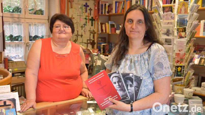 Monika Etterer und Geschäftsführerin Maria Unterstein zeigen einige Bücher, DVDs und andere Dinge, die im Klosterladen in Tirschenreuth erhältlich sind. Bild: ubb