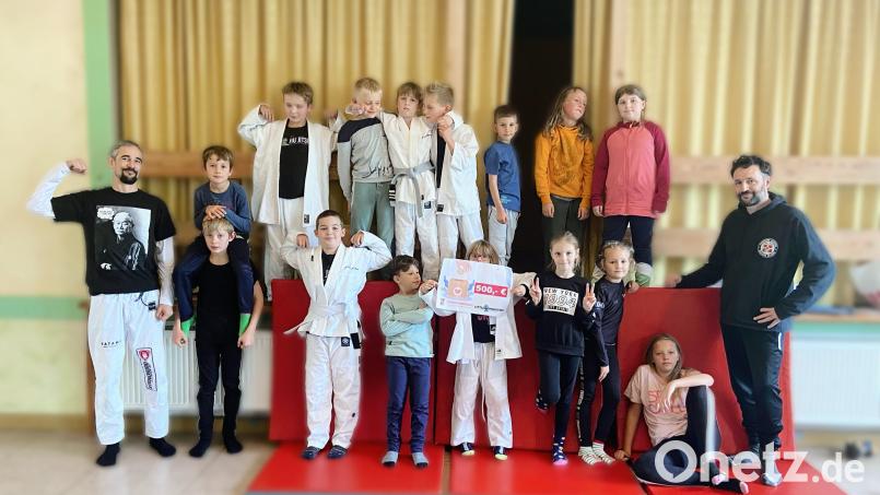 Die Jiu-Jitsu-Kindergruppe um Trainer Andi Fachtan (links) spendete an die Kinderkrebshilfe Nordoberpfalz. Bild: Andi Fachtan/exb