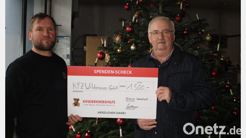 Helmut Wildenauer (links) überreicht einen Spendenscheck in Höhe von 1.500 an Herbert Putzer, Vorsitzendem der Kinderkrebshilfe. Bild: Silvia Wildenauer