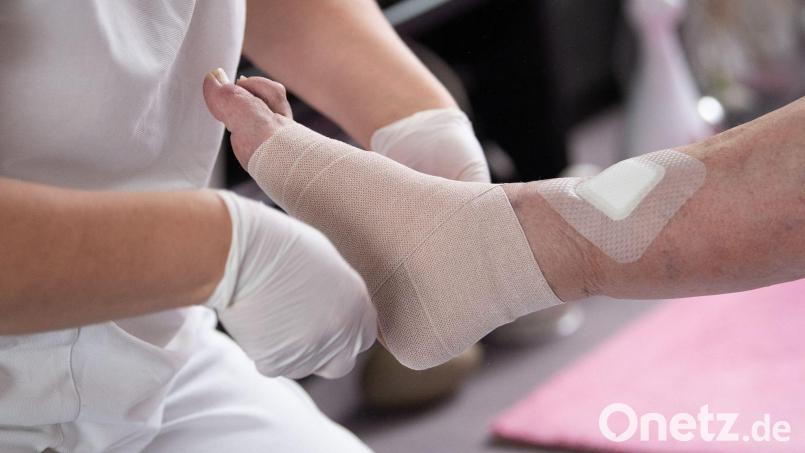 Vor allem die ambulante Pflege wird immer mehr zu einem Problem. Der Bedarf steigt, neue Fachkräfte sind vielerorts nicht zu finden. Auf dem Bild legt eine Pflegefachkraft in der ambulanten Pflege einen Kompressionsverband an. Symbolbild: Sebastian Gollnow/dpa
