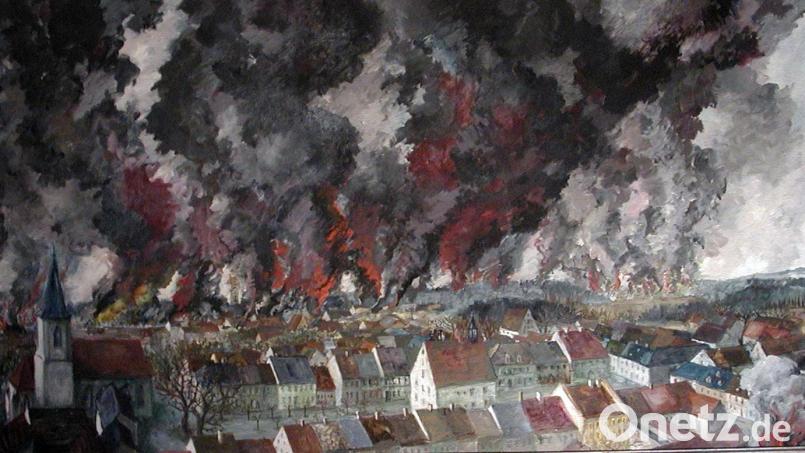 Im Sitzungssaal des Rathauses hängt das Bild „Grafenwöhr in Flammen“. Der geborene Grafenwöhrer Norbert Richter-Scrobinhusen malte es aus dem Gedächtnis. Es zeigt die Ansicht des 8. Aprils 1945 vom Birka aus über die Altstadt zum Lager. Bild: mor