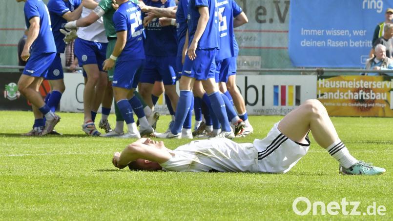 Enttäuschung pur: Während die Spieler vom Würzburger FV ihren 2:1-Auswährtserfolg feiern, liegt Martin Popp (vorne) von der DJK Ammerthal fix und fertig auf dem Rasen. Bild: Hubert Ziegler