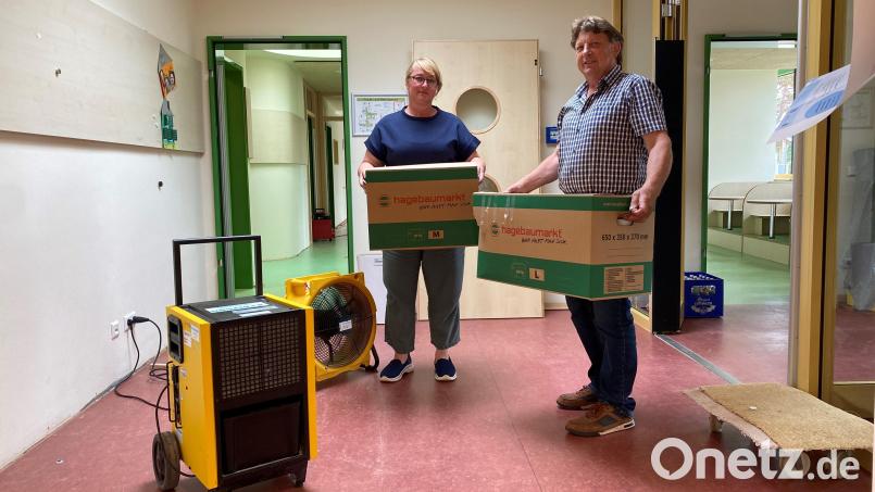 Kindergartenleiterin Dana Graf und Zweiter Bürgermeister Andreas Altmann packen an: Material und Spielsachen werden in Umzugskartons zwischengelagert. Lüftungsgeräte ziehen die Feuchte aus den Räumen. Bild: Völkl