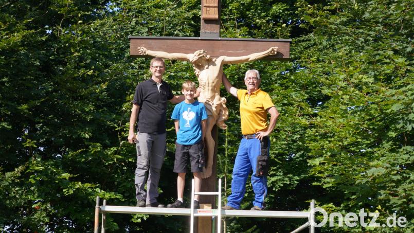 Josef Greiner, sein Sohn Lorenz und Josef Gmeiner (von links) installieren die neue Figur am Kreuz am Fahrenberger Freialtar. Bild: fvo